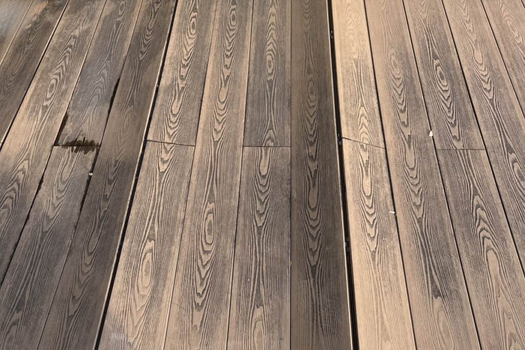 Capped vs. Uncapped Composite Decking: What Builders Need to Know 4 uncapped composite decking cracking weathering closeup