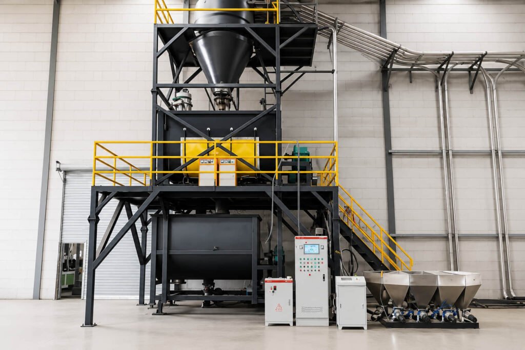 Automated material blending equipment preparing wood fiber and polymer mix for composite products
