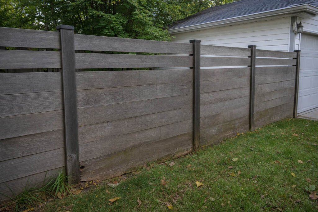 Composite Fencing vs Wood Fencing: Which Costs Less Over 15 Years? 2 weathered cedar fence aging and rot